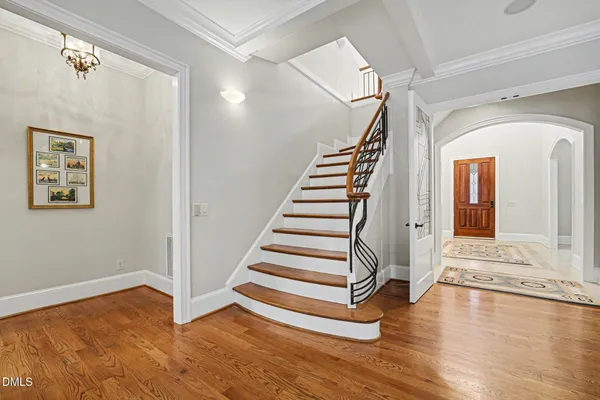 a view of entryway and hall with wooden floor