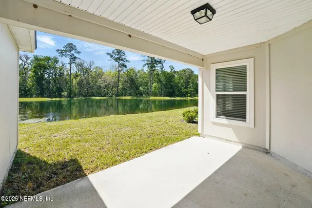 a view of a swimming pool with a yard