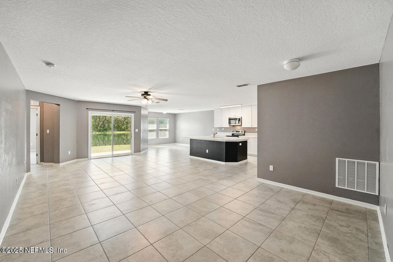11624 Palladio Way Jacksonville, FL 32218 - Photo 3 of 15 a view of an empty room with a kitchen