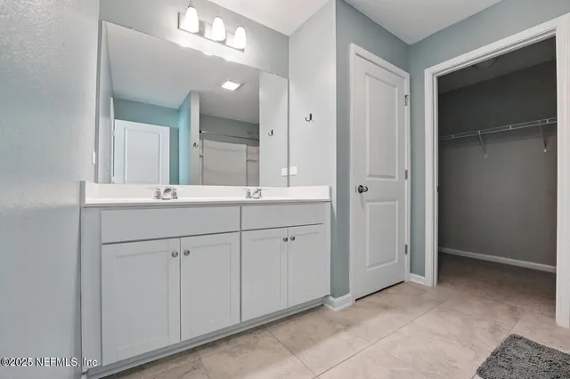 wooden bathroom with a sink and a mirror