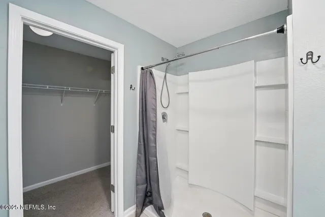 a bathroom with a glass door shower