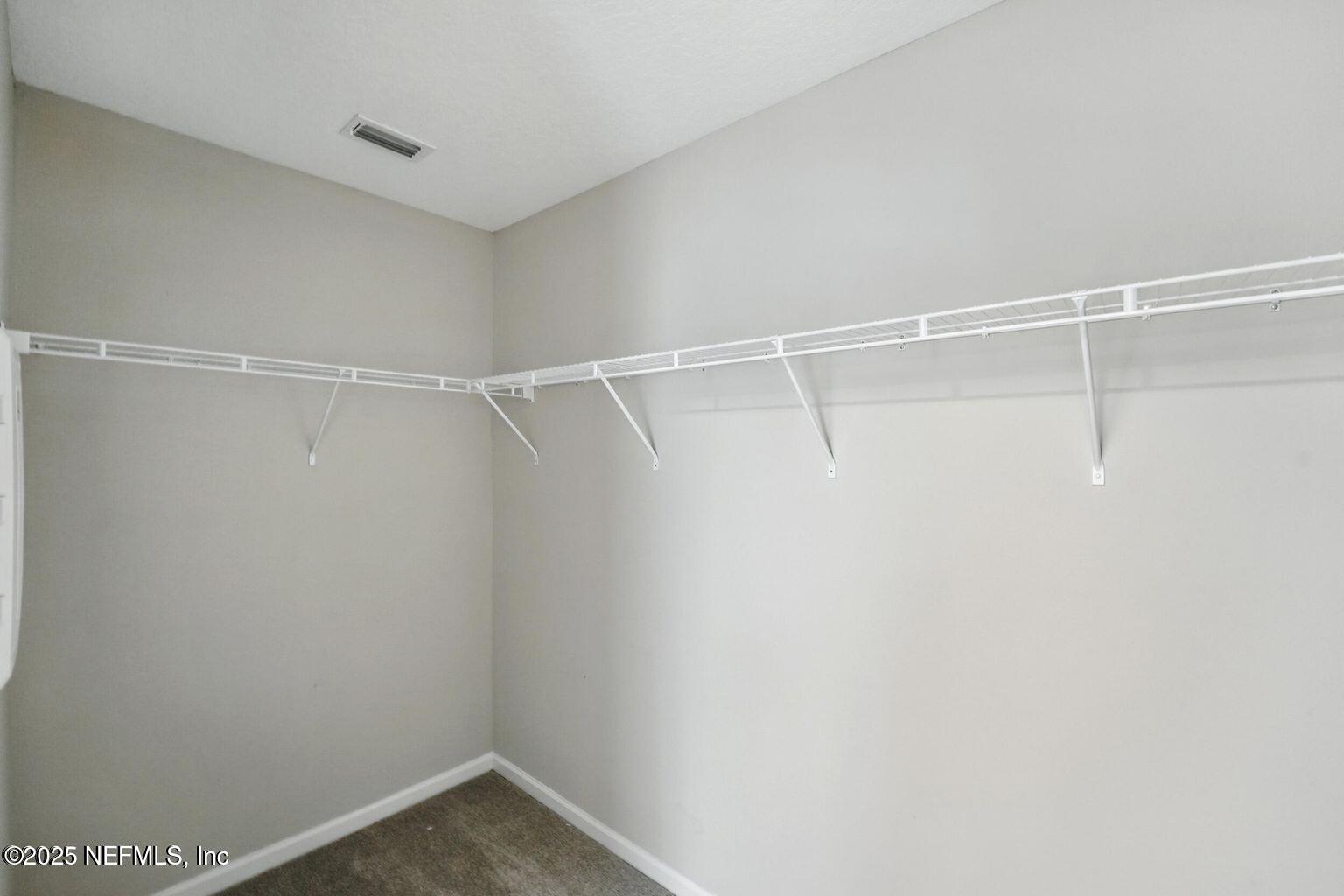 11624 Palladio Way Jacksonville, FL 32218 - Photo 10 of 15 a view of a room with racks on the wall
