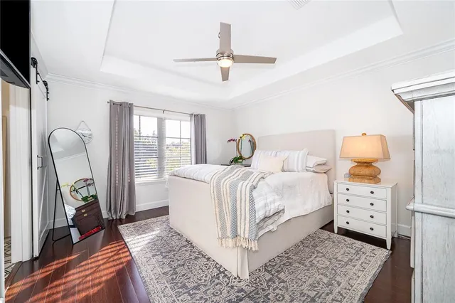 a bedroom with a bed a rug and wooden floor