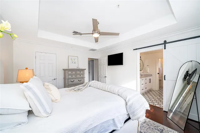 a bedroom with a large bed and a tv