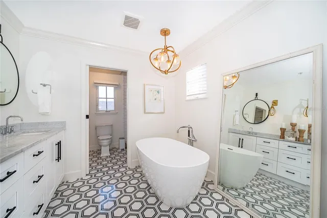 a bathroom with a sink a toilet and a mirror