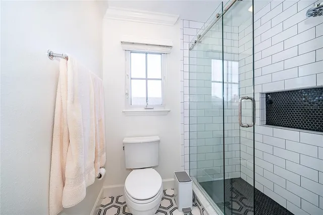 a white toilet sitting next to a bathroom sink