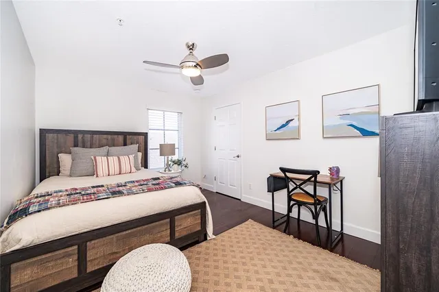 a bedroom with a bed a table and chair