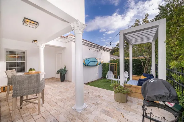a view of a house with backyard sitting area and garden