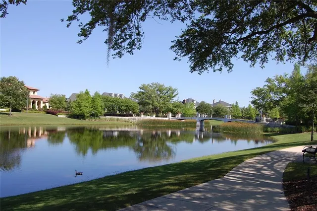 a view of a lake with houses in the back