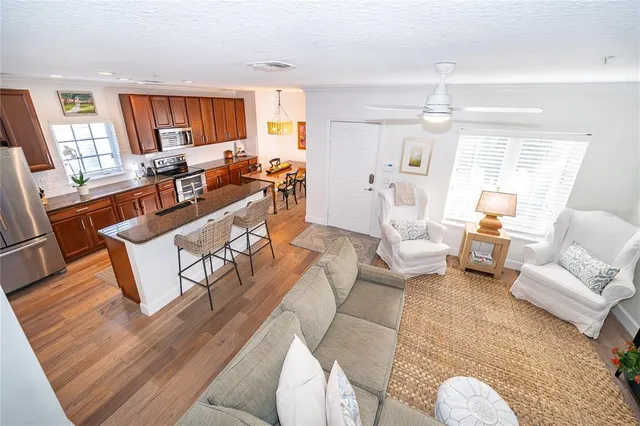 a living room with furniture fireplace and a large window