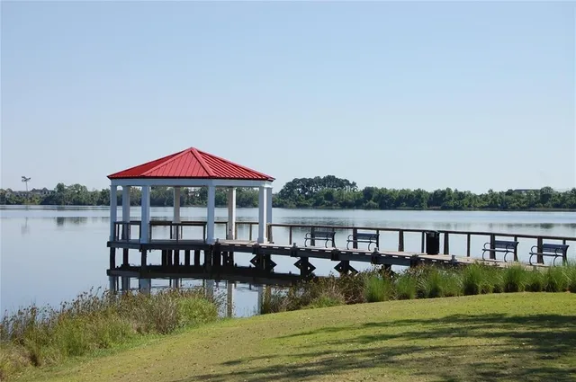 a view of a house with a yard from a lake view