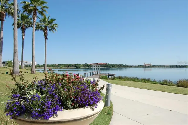 a view of a lake with a table and chairs