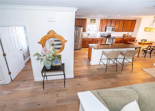 a living room with furniture a rug a table and a large window