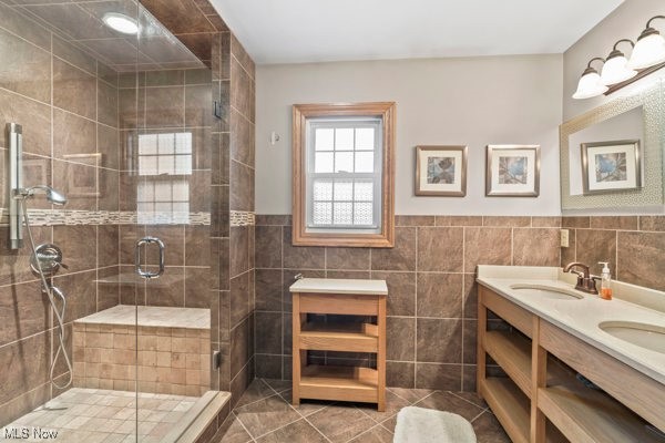 14413 Macklin Road New Springfield, OH 44443 - Photo 19 of 49 Bathroom featuring tile walls, double vanity, dark tile patterned floors, a shower stall, and a wainscoted wall