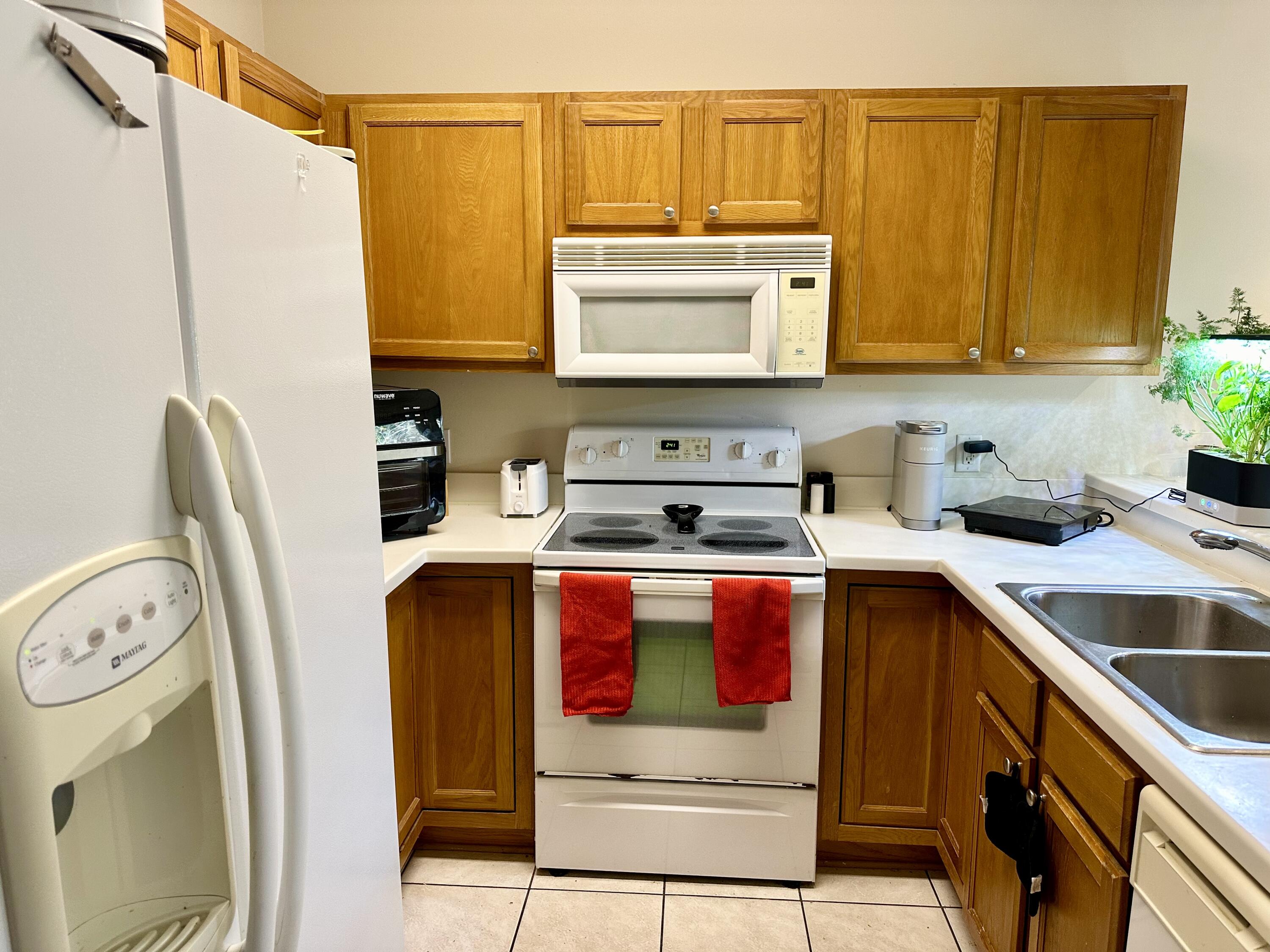 732 East Mack Bayou Drive, Unit 2 Santa Rosa Beach, FL 32459 - Photo 12 of 43 a kitchen with stainless steel appliances granite countertop a sink a stove and a refrigerator