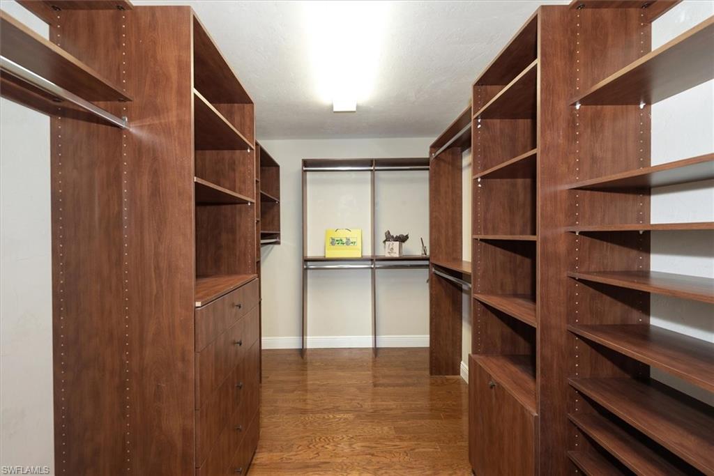 2252 Royal Lane Naples, FL 34112 - Photo 14 of 42 Spacious California Master walk-in closet with wood flooring