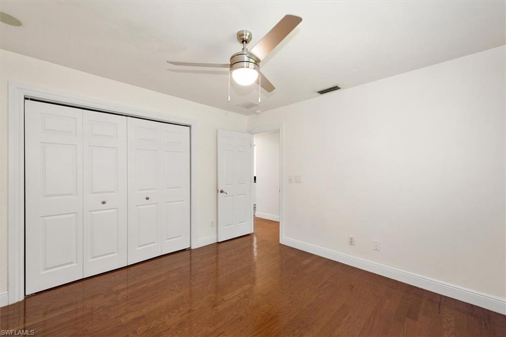 2252 Royal Lane Naples, FL 34112 - Photo 18 of 42 Third bedroom with a large closet, wood floors, and stylish ceiling fan