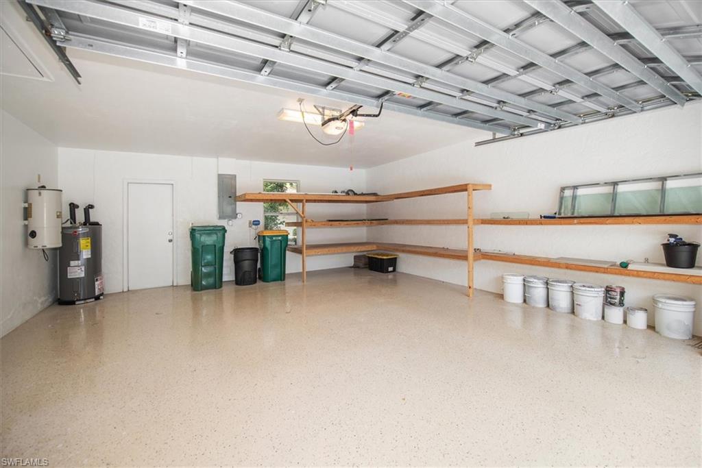 2252 Royal Lane Naples, FL 34112 - Photo 26 of 42 Garage with electric panel and water heater and epoxy covered flooring