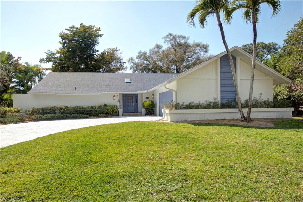 2252 Royal Lane Naples, FL 34112 - Photo 35 of 42 View of front of property, driveway, stucco siding, and an attached 2 car garage
