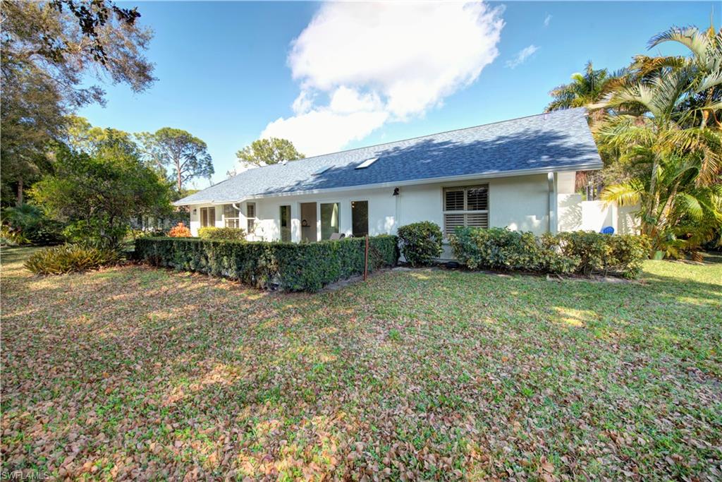 2252 Royal Lane Naples, FL 34112 - Photo 37 of 42 Rear view of property with a yard, stucco siding, and NEW roof with shingles