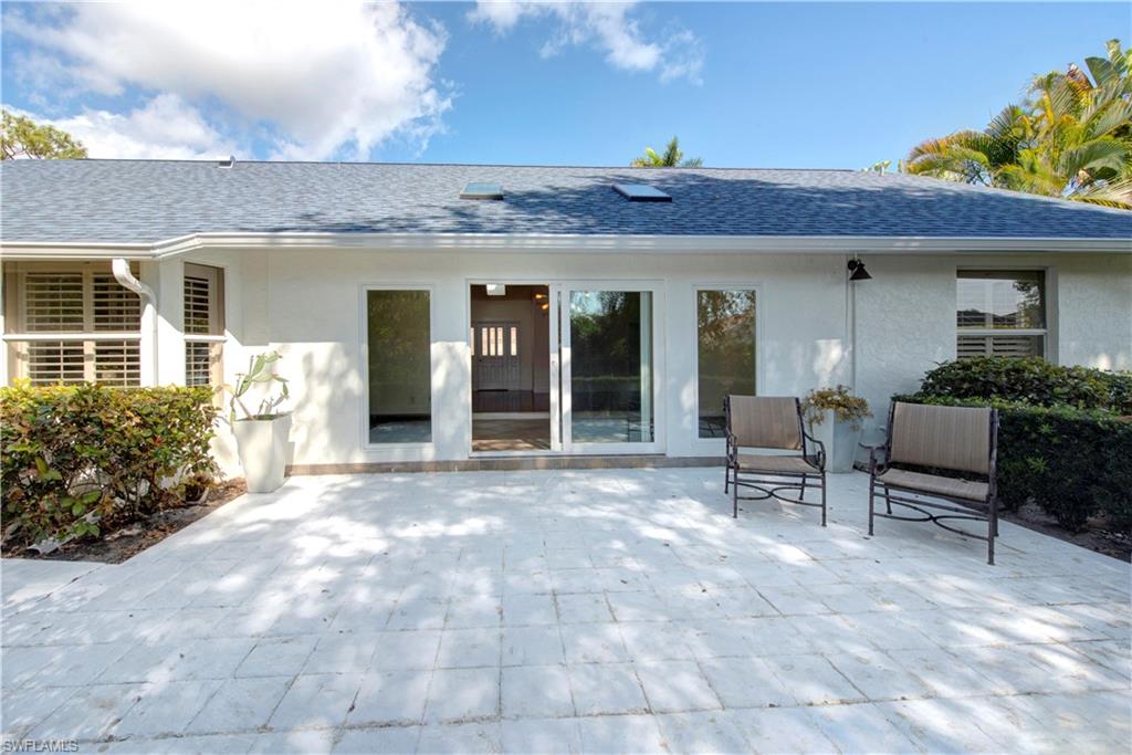 2252 Royal Lane Naples, FL 34112 - Photo 39 of 42 Back of property featuring stucco siding, NEW roof and gutters and a patio