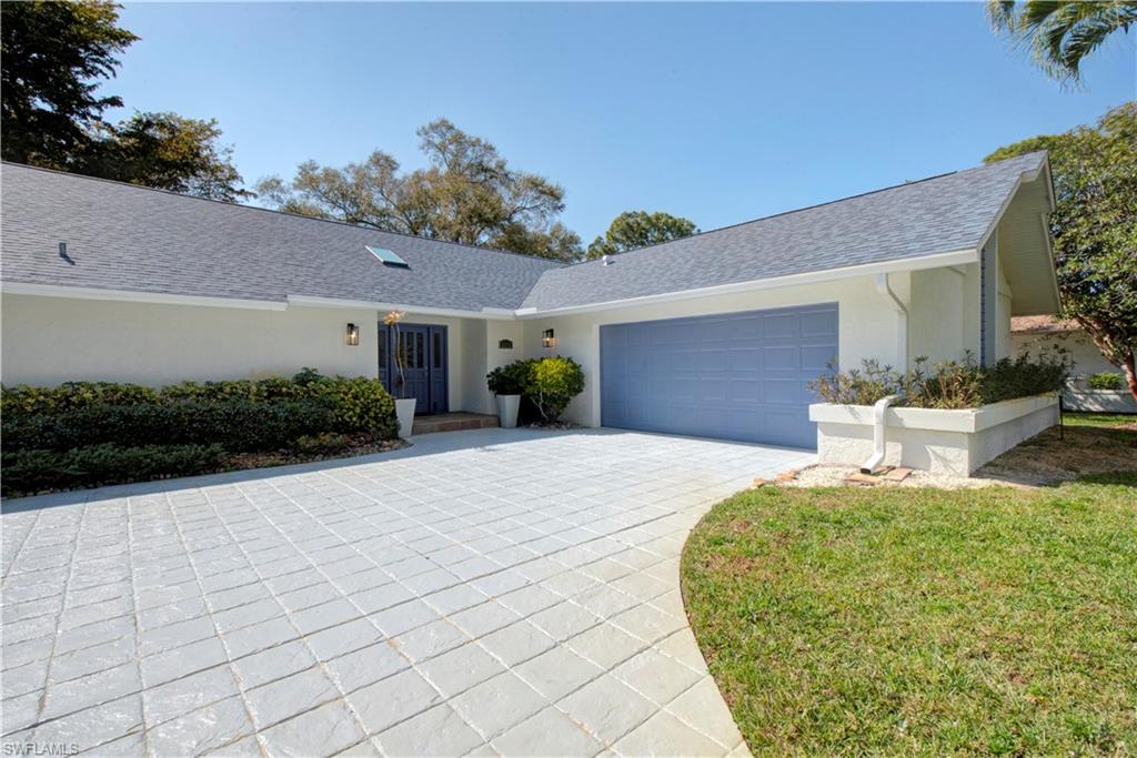 2252 Royal Lane Naples, FL 34112 - Photo 41 of 42 Single story home featuring an attached garage, driveway, stucco siding, and a NEW shingled roof