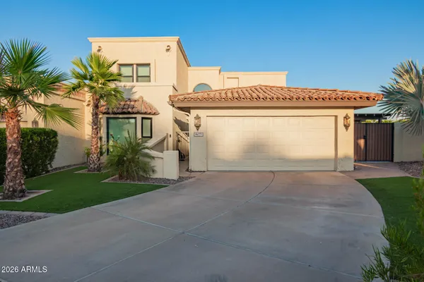 a view of a house with a yard and garage