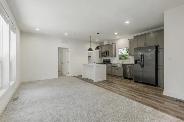 a kitchen with refrigerator and cabinets