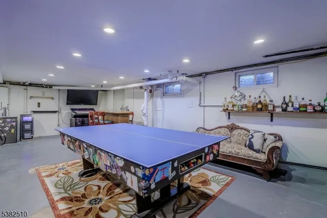 a living room with furniture and kitchen view