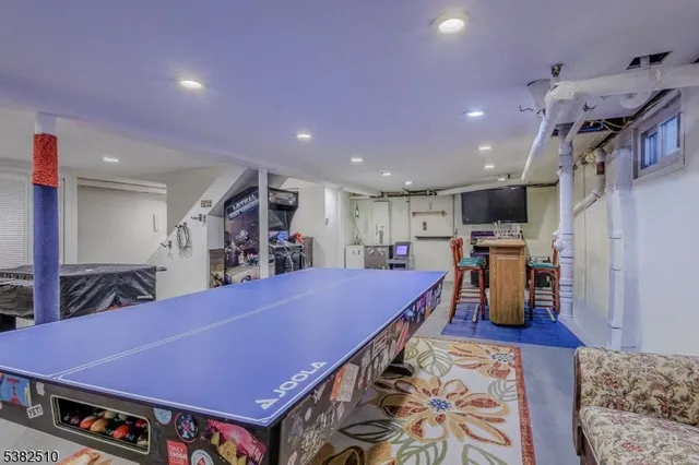 a kitchen with stainless steel appliances lots of furniture