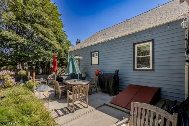 a view of backyard of house with seating space