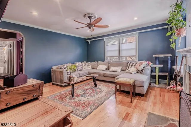 a living room with furniture and a chandelier