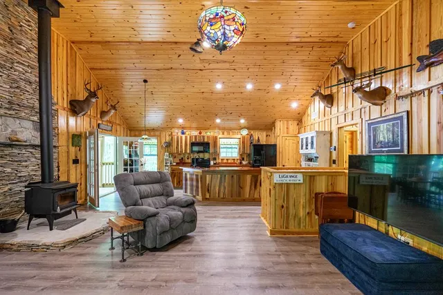 a bedroom with a bed a window and a chandelier