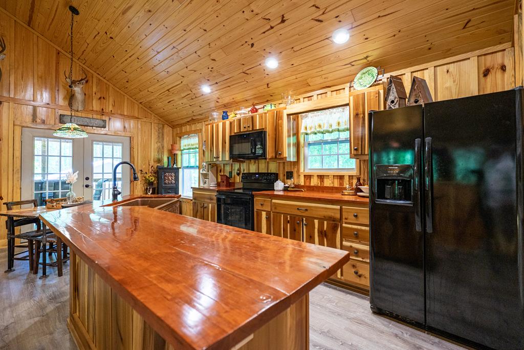 153 North Whatley Road LaGrange, GA 30240 - Photo 28 of 67 a dining hall with stainless steel appliances kitchen island granite countertop a refrigerator a stove and a sink with wooden cabinets