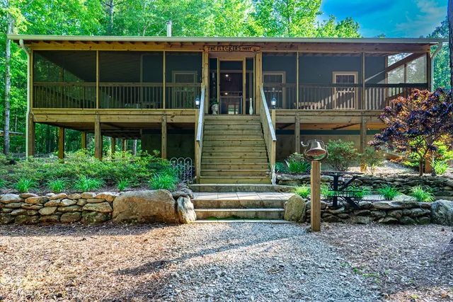 a view of house with a yard and sitting area