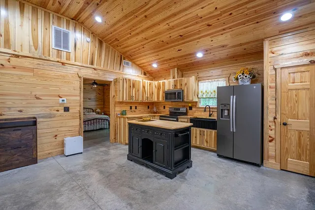 a view of a park with plants and large trees