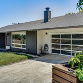 a front view of a house with a garden