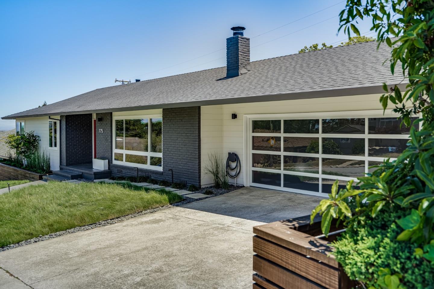 a front view of a house with a garden