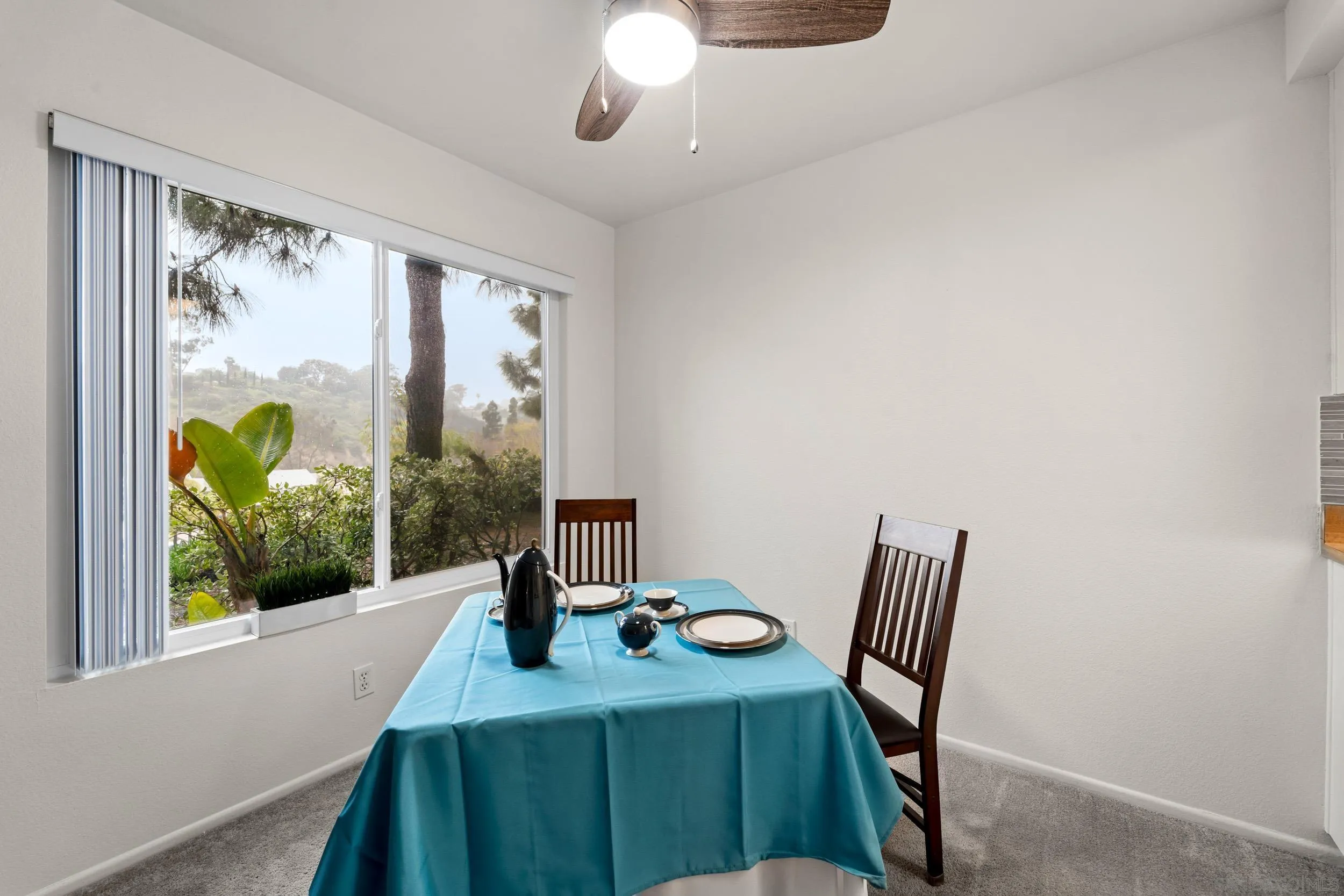 8640 Via Mallorca, Unit A La Jolla, CA 92037 - Photo 12 of 24 a view of a dining room with furniture large windows and wooden floor