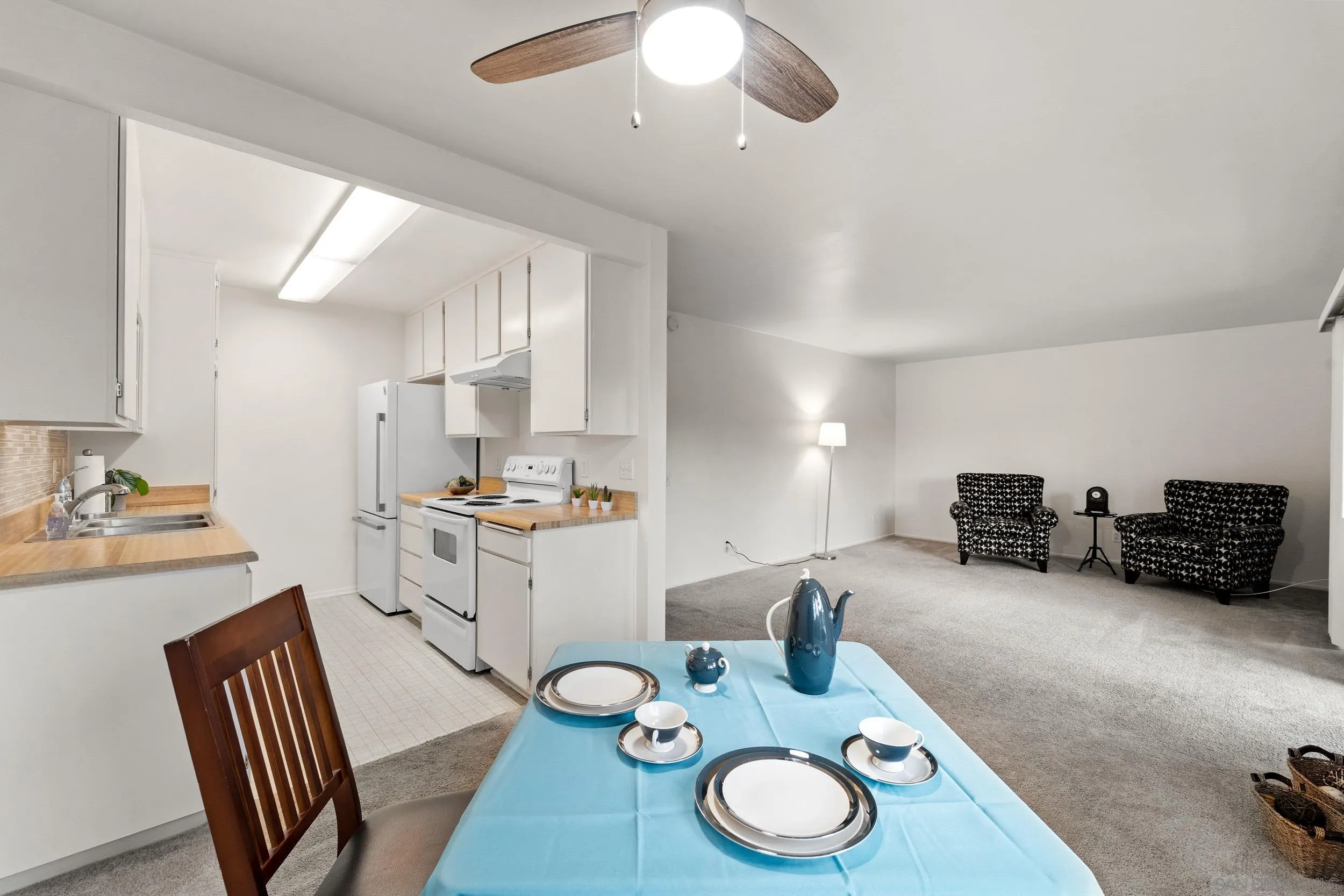 8640 Via Mallorca, Unit A La Jolla, CA 92037 - Photo 15 of 24 a kitchen with sink a stove and chairs