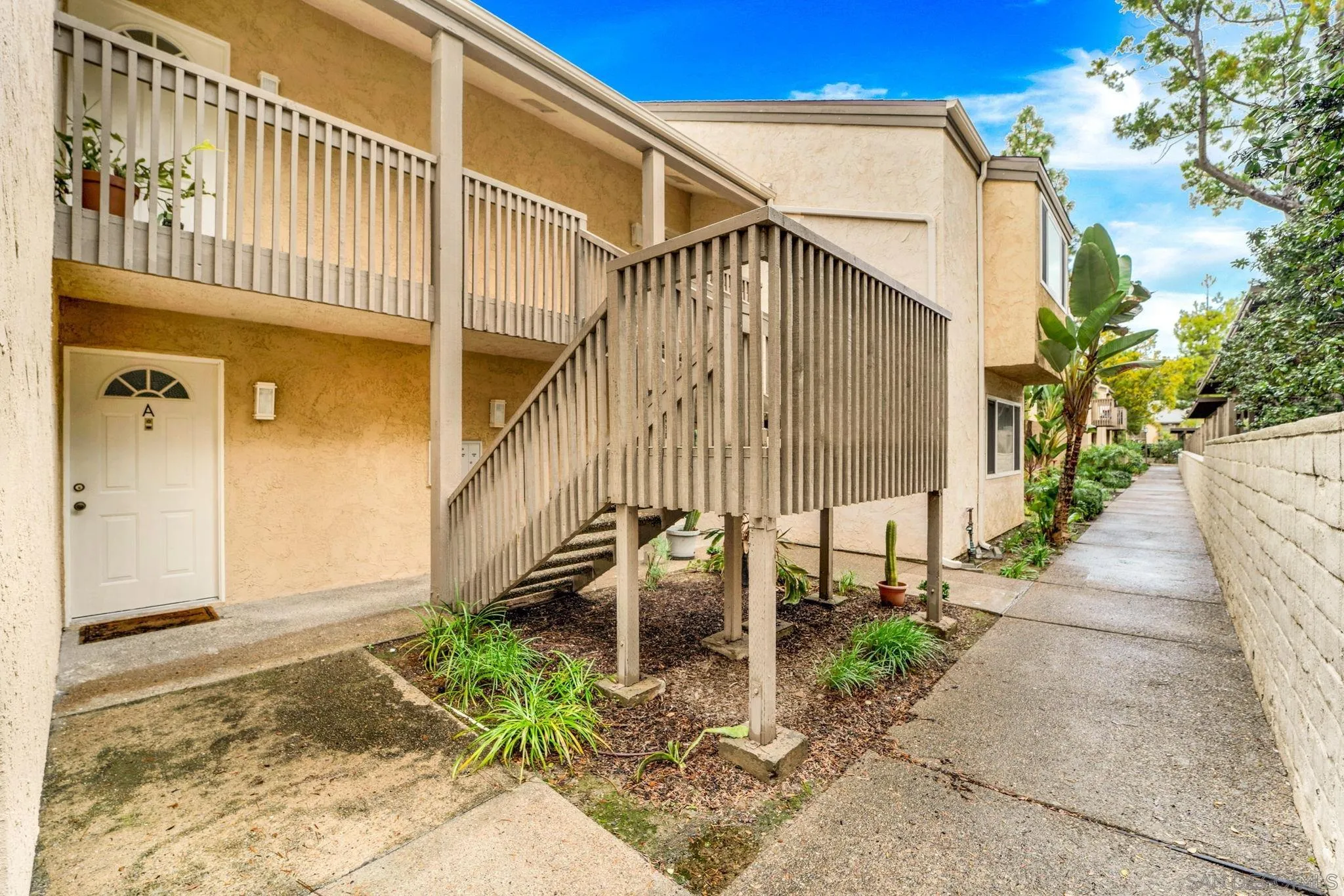 8640 Via Mallorca, Unit A La Jolla, CA 92037 - Photo 3 of 24 a front view of a house with a yard
