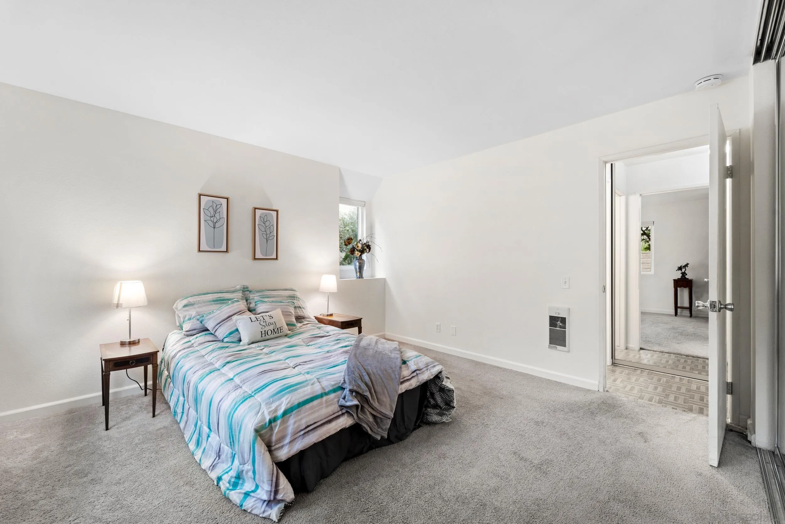 8640 Via Mallorca, Unit A La Jolla, CA 92037 - Photo 4 of 24 a bedroom with a bed and a lamp