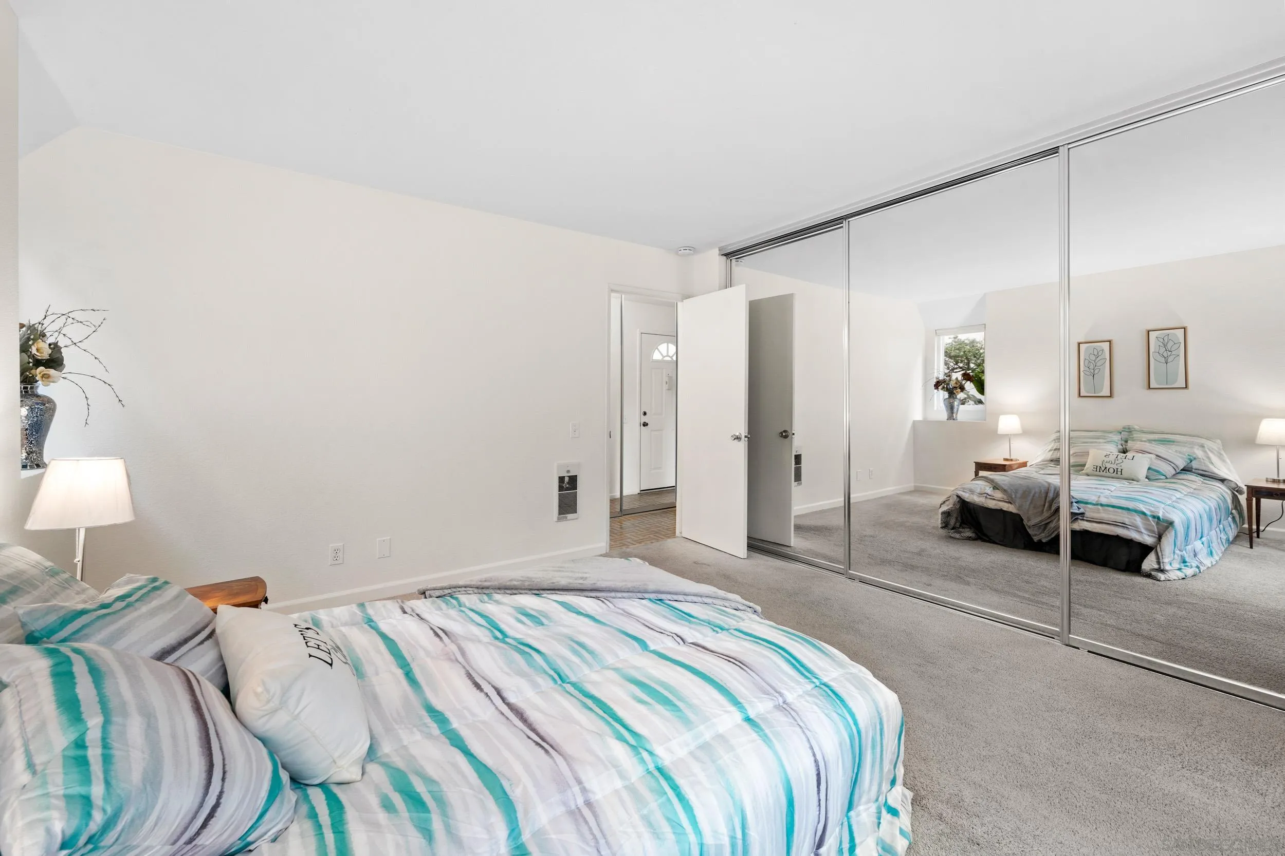 8640 Via Mallorca, Unit A La Jolla, CA 92037 - Photo 5 of 24 a bedroom with a bed and a lamp