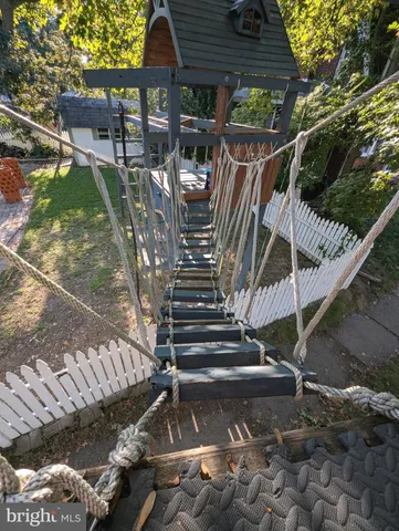 a dining room with wooden floor a chandelier a wooden table and chairs
