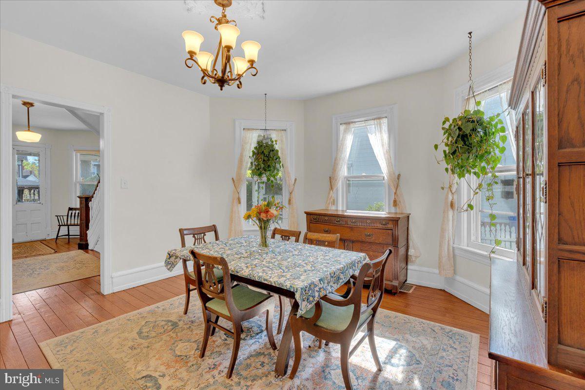 45 Broad Street Mount Holly, NJ 08060 - Photo 21 of 58 a dining room with furniture potted plants and wooden floor