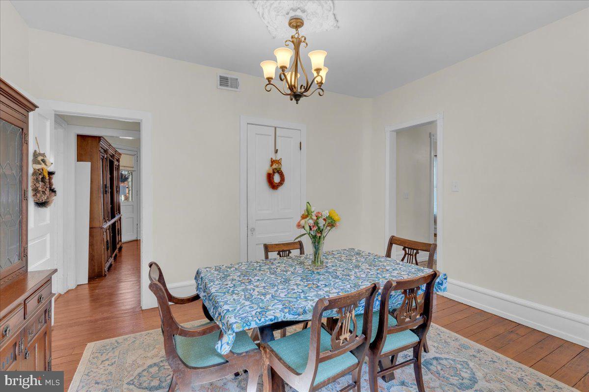 45 Broad Street Mount Holly, NJ 08060 - Photo 22 of 58 a view of a dining room with furniture wooden floor and a chandelier