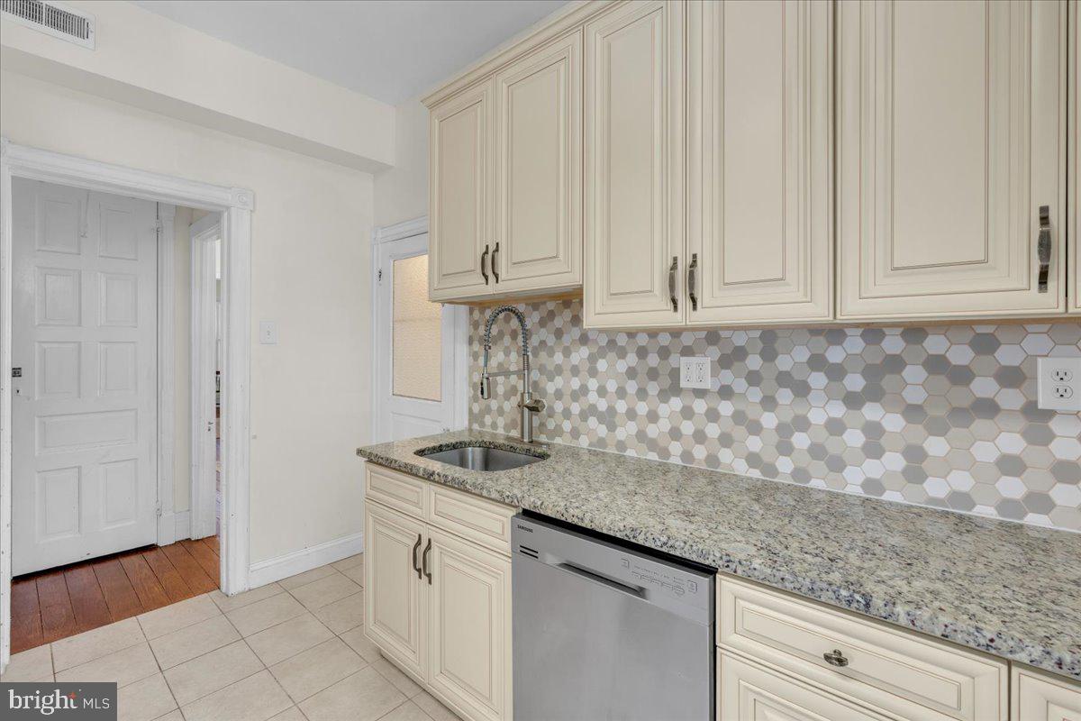 45 Broad Street Mount Holly, NJ 08060 - Photo 26 of 58 a kitchen with stainless steel appliances granite countertop white cabinets and a sink