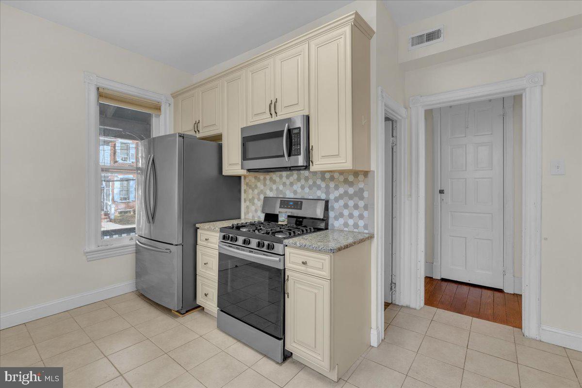 45 Broad Street Mount Holly, NJ 08060 - Photo 27 of 58 a kitchen with stainless steel appliances granite countertop a stove a refrigerator and a microwave