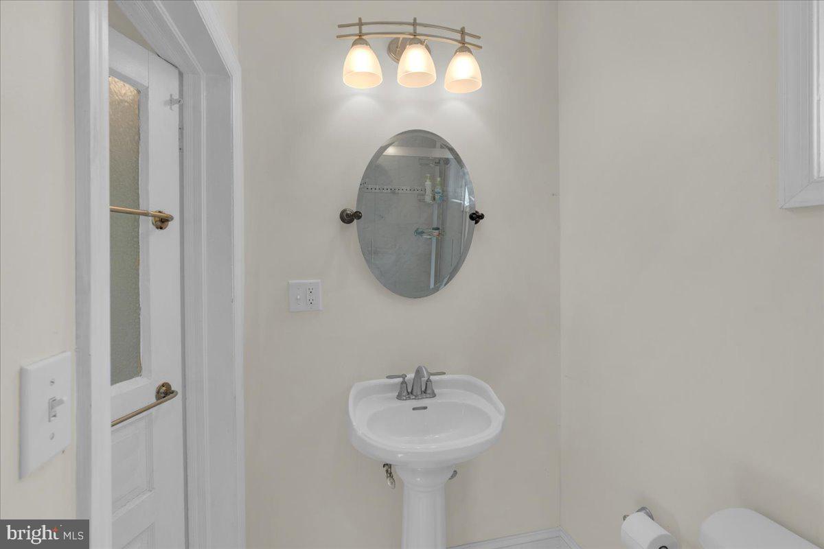 45 Broad Street Mount Holly, NJ 08060 - Photo 28 of 58 a bathroom with a sink and a mirror