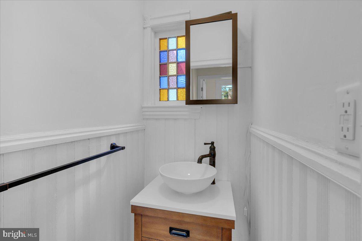 45 Broad Street Mount Holly, NJ 08060 - Photo 35 of 58 a bathroom with a sink and a mirror